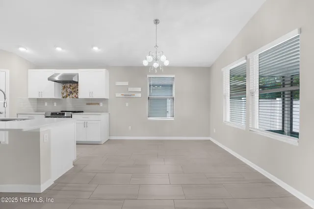 a open kitchen with white cabinets and a dishwasher