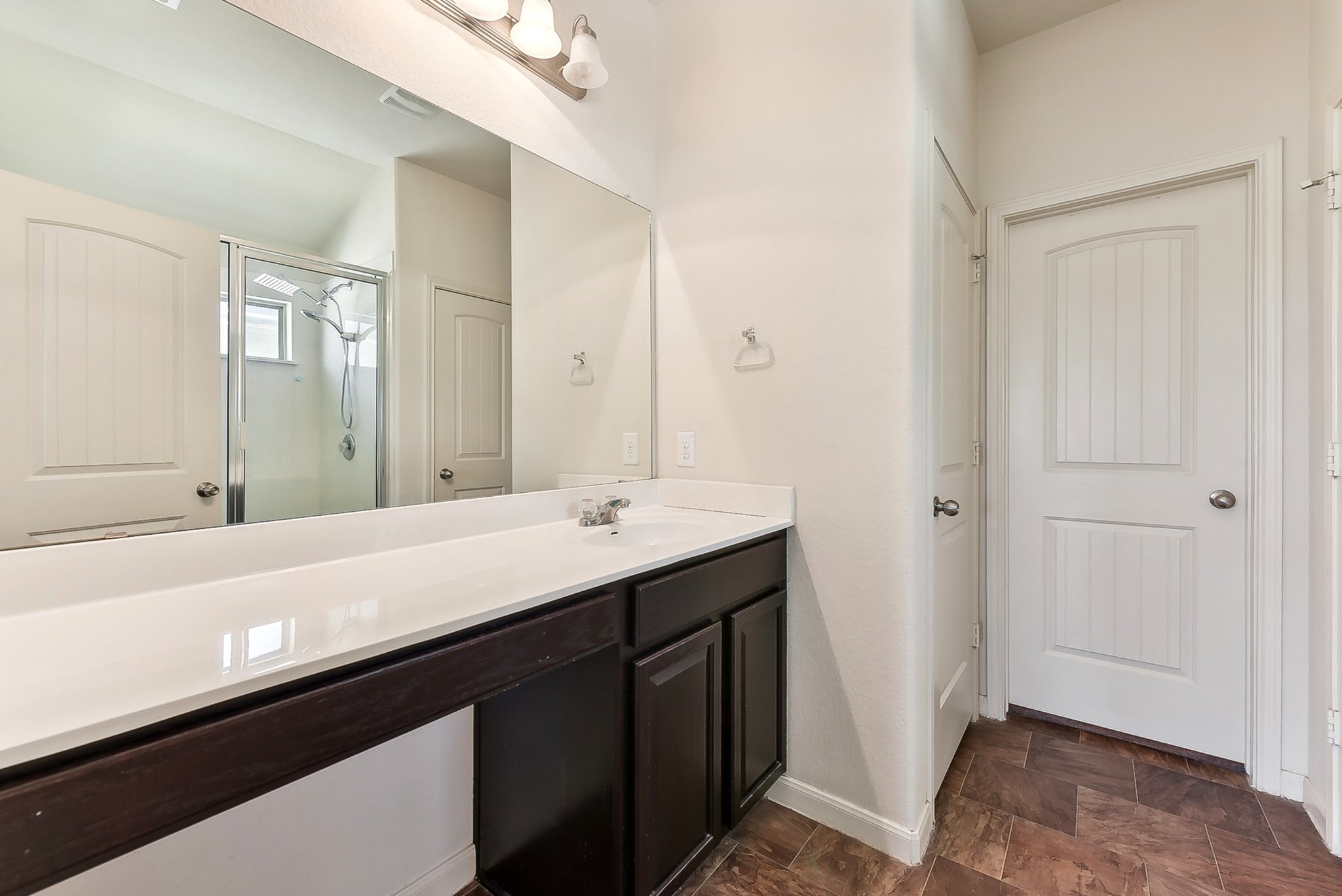 310 Potters Peak Way Georgetown, TX 78626 - Photo 17 of 21 Spacious bathroom vanity featuring a white countertop, dual sinks, and dark wood-finish cabinetry
