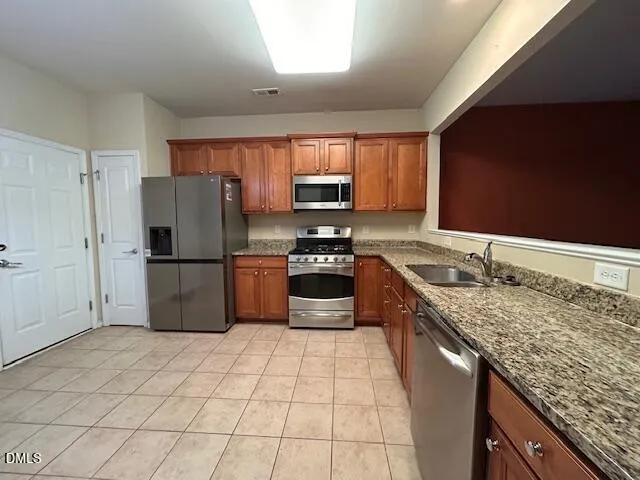 a kitchen with a stove a sink and a refrigerator