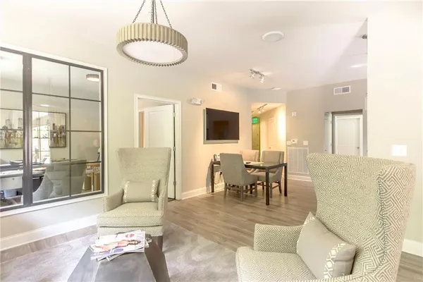 a living room with furniture a window and a chandelier
