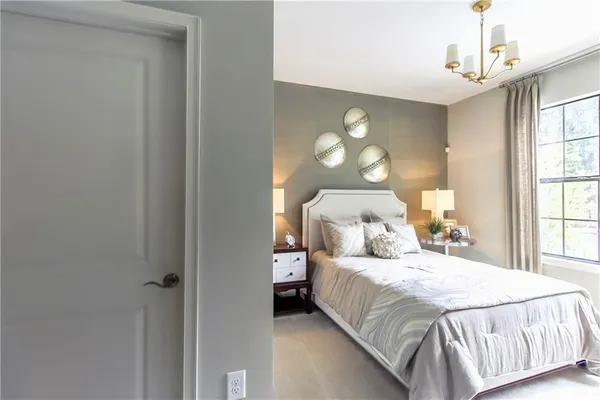 a bedroom with a bed and a large window