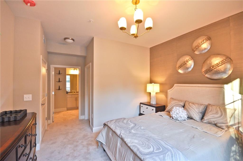 4011 Roswell Road, Unit 2311 Atlanta, GA 30342 - Photo 14 of 39 a bedroom with a bed and a chandelier