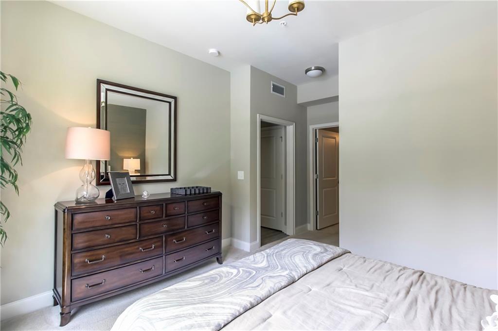 4011 Roswell Road, Unit 2311 Atlanta, GA 30342 - Photo 17 of 39 a bedroom with a bed and a mirror