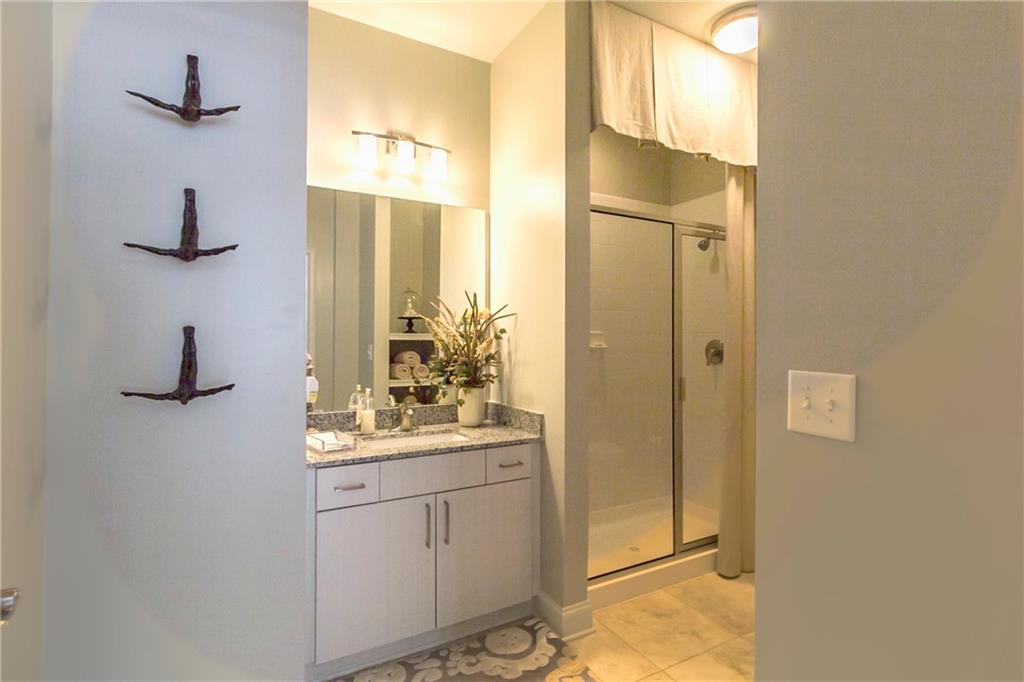 4011 Roswell Road, Unit 2311 Atlanta, GA 30342 - Photo 18 of 39 a bathroom with a sink and a mirror