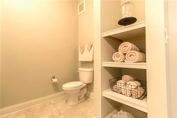 a bathroom with a toilet and a shower curtain