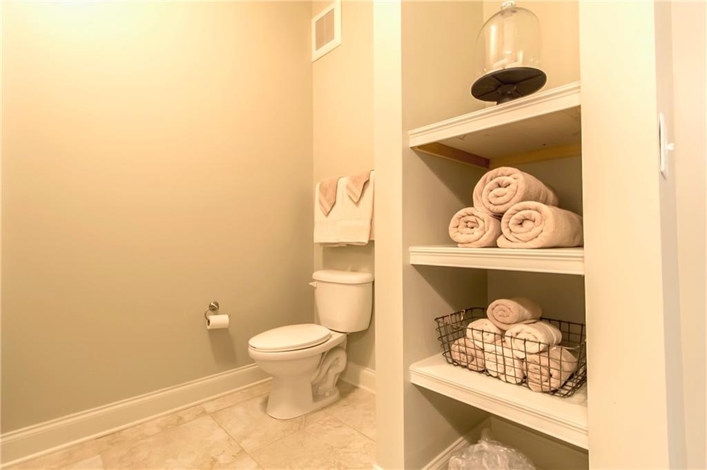 4011 Roswell Road, Unit 2311 Atlanta, GA 30342 - Photo 21 of 39 a bathroom with a toilet and a shower curtain