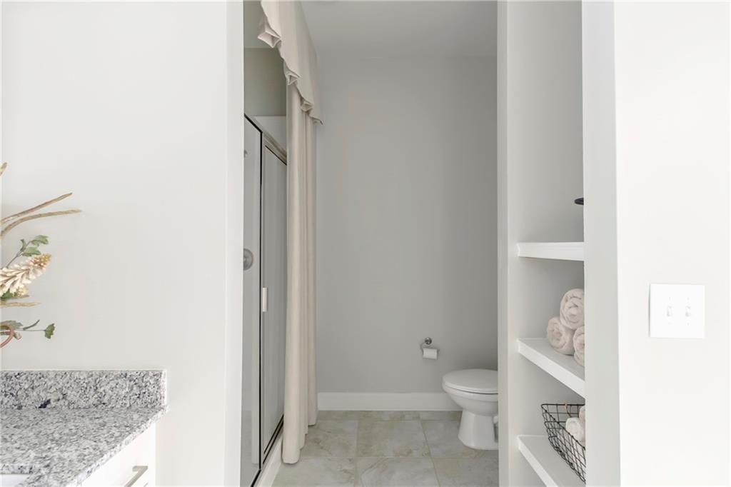 4011 Roswell Road, Unit 2311 Atlanta, GA 30342 - Photo 22 of 39 a bathroom with a granite countertop toilet and a sink