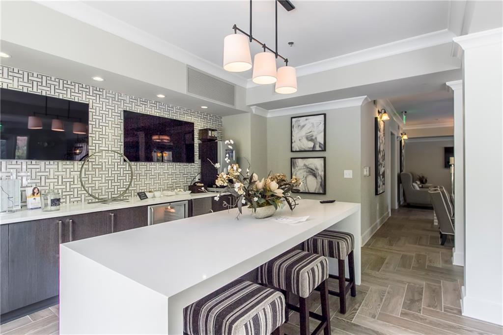 4011 Roswell Road, Unit 2311 Atlanta, GA 30342 - Photo 26 of 39 a large kitchen with a table and chairs