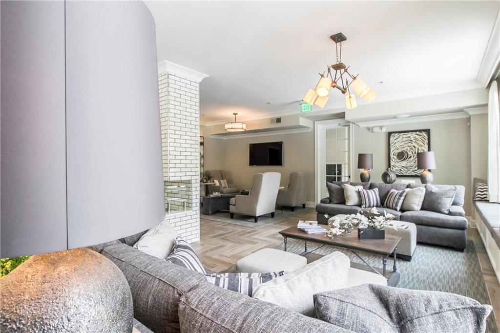 4011 Roswell Road, Unit 2311 Atlanta, GA 30342 - Photo 28 of 39 a living room with furniture chandelier and a fireplace