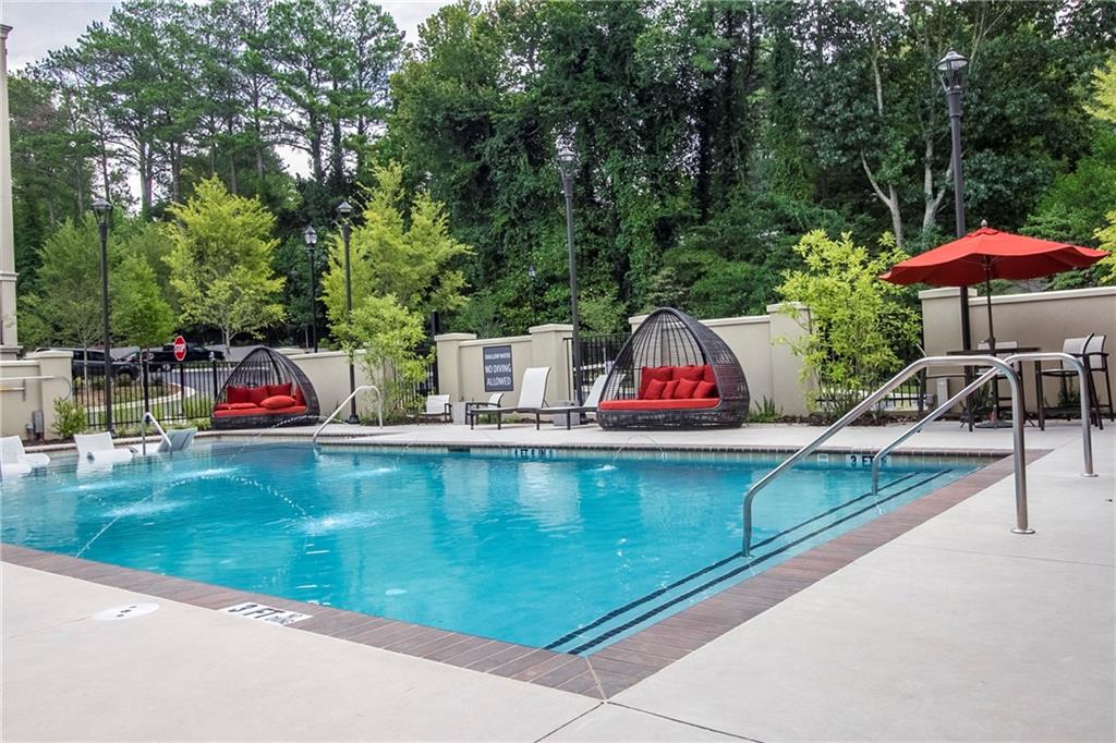 4011 Roswell Road, Unit 2311 Atlanta, GA 30342 - Photo 34 of 39 an outdoor space with furniture and umbrella