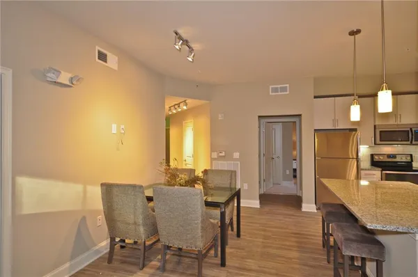a view of a dining room with furniture and wooden floor
