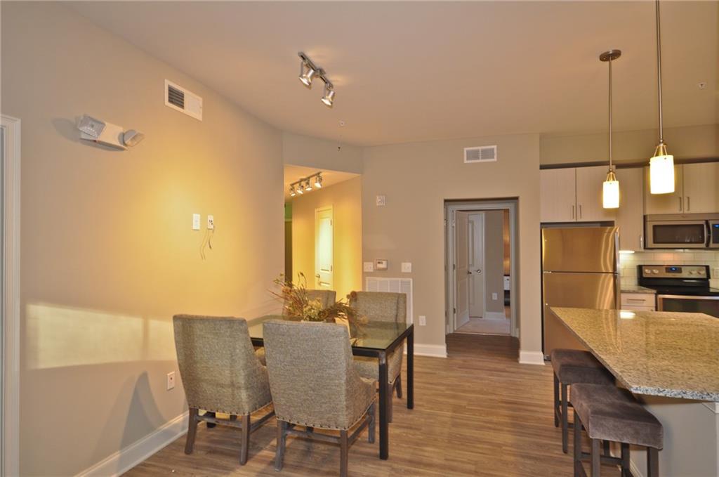 4011 Roswell Road, Unit 2311 Atlanta, GA 30342 - Photo 9 of 39 a view of a dining room with furniture and wooden floor