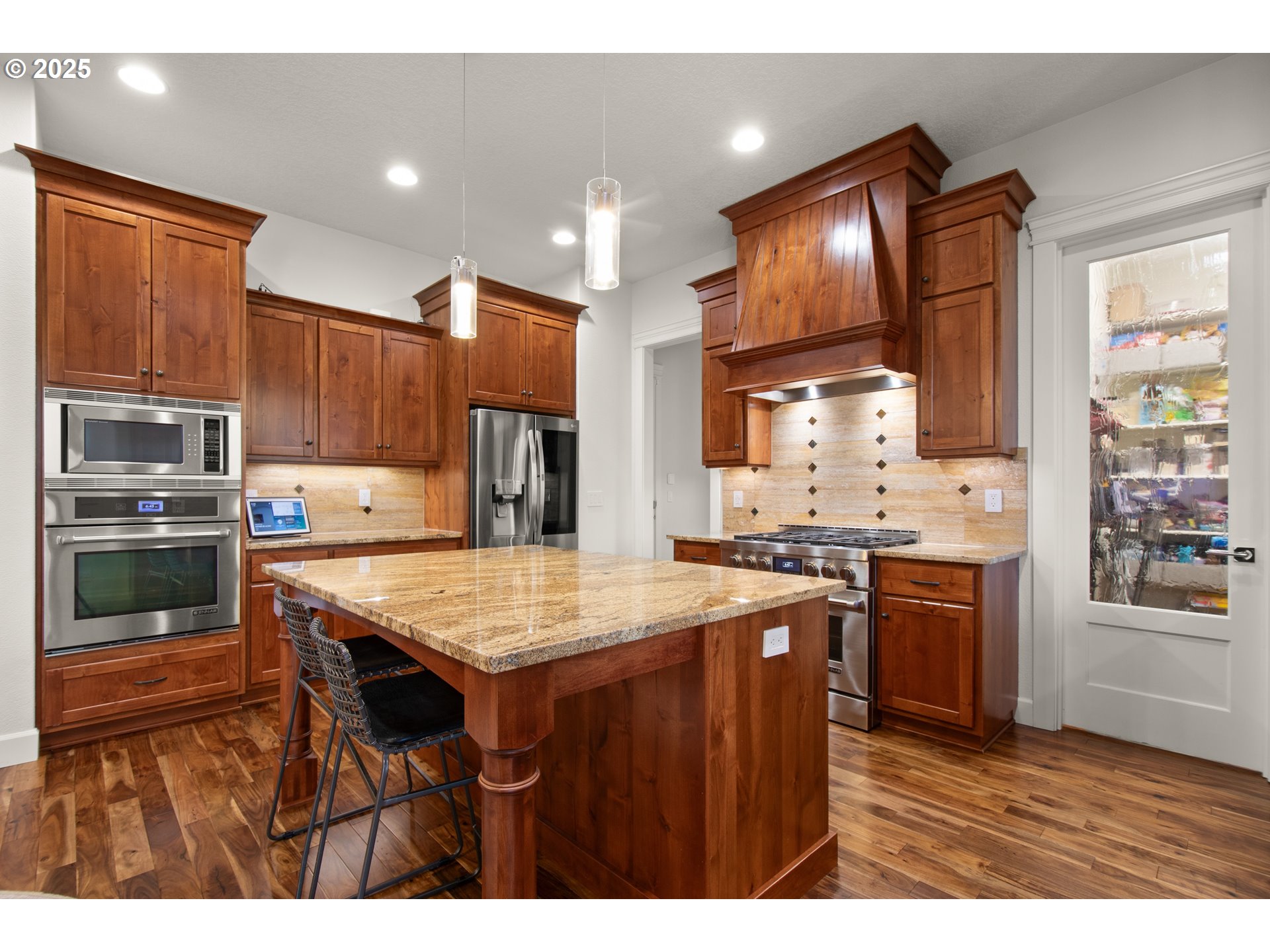 2215 Northwest 17th Avenue Camas, WA 98607 - Photo 11 of 48 a kitchen with stainless steel appliances kitchen island granite countertop a stove refrigerator and cabinets