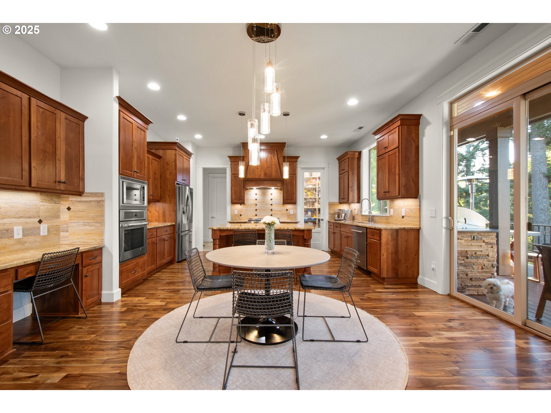 2215 Northwest 17th Avenue Camas, WA 98607 - Photo 10 of 48 a kitchen with stainless steel appliances kitchen island granite countertop a refrigerator a stove a sink a dining table and chairs with wooden floor