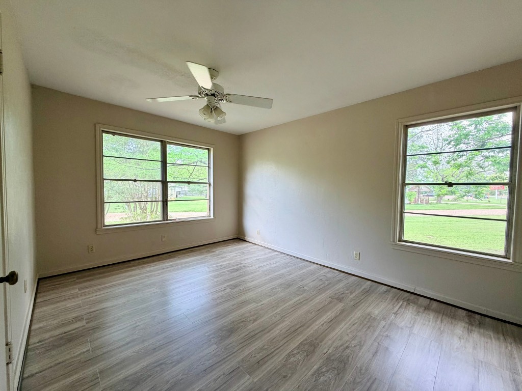 612 Keith Street Kennard, TX 75847 - Photo 13 of 15 a view of an empty room with wooden floor and a window