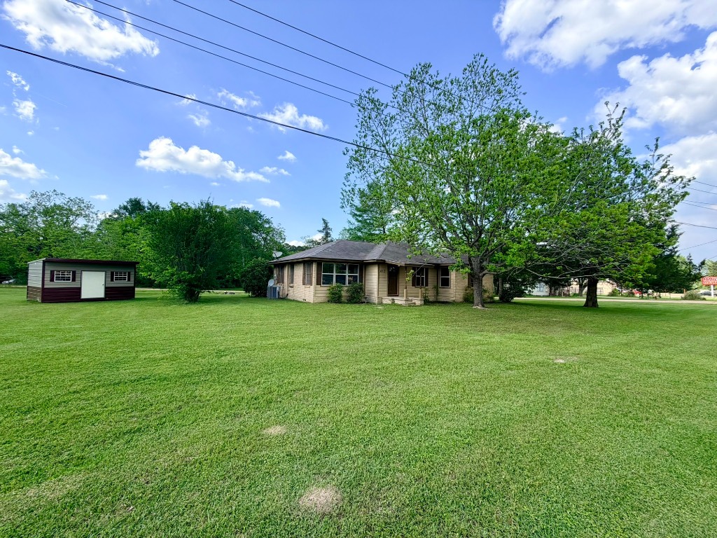 612 Keith Street Kennard, TX 75847 - Photo 2 of 15 a front view of a house with a garden