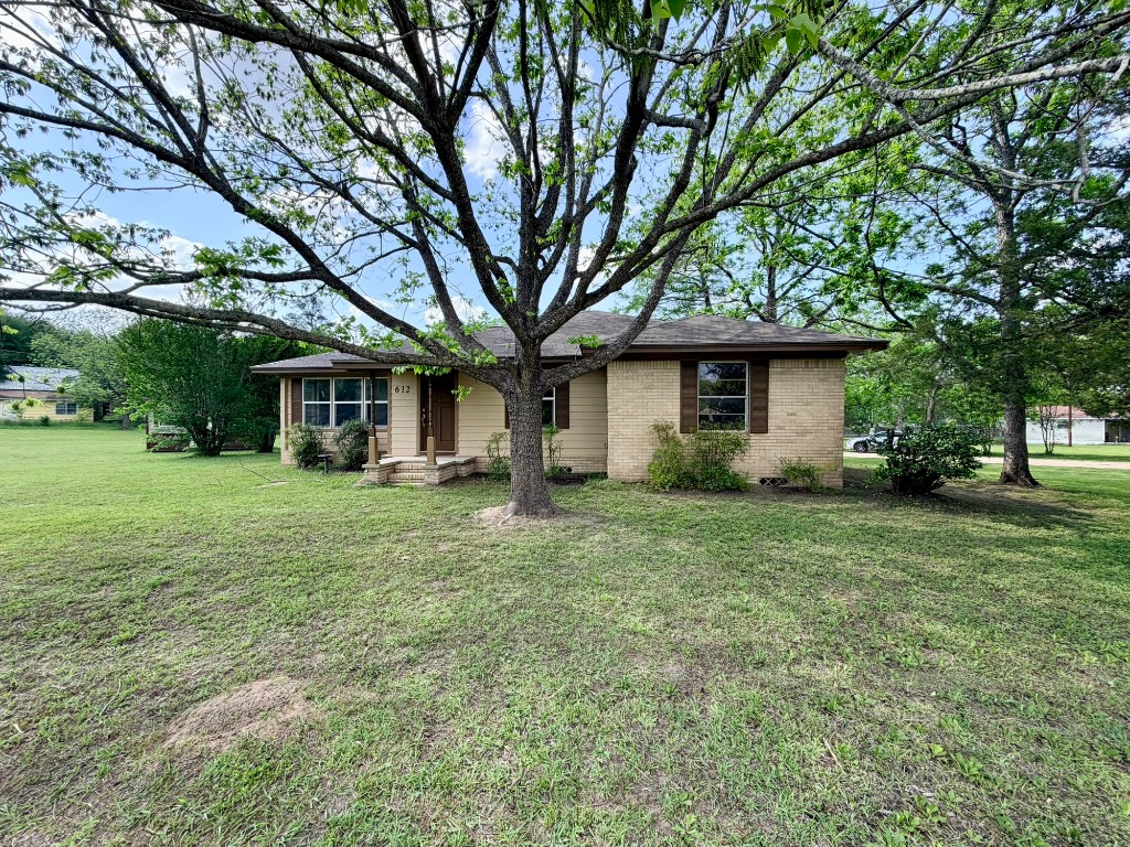 612 Keith Street Kennard, TX 75847 - Photo 3 of 15 a front view of a house with a garden