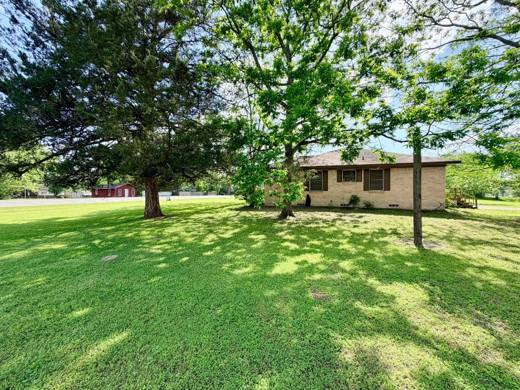 612 Keith Street Kennard, TX 75847 - Photo 4 of 15 a view of a house with a backyard