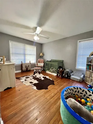 a bedroom with filled bed and a window