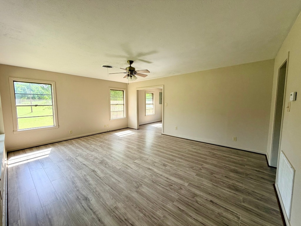 612 Keith Street Kennard, TX 75847 - Photo 8 of 15 a view of an empty room with a window and wooden floor