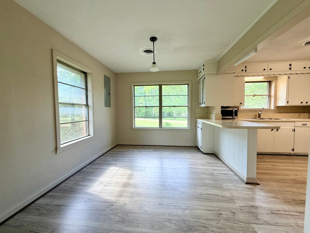 612 Keith Street Kennard, TX 75847 - Photo 9 of 15 a kitchen with stainless steel appliances granite countertop a sink cabinets and a large window