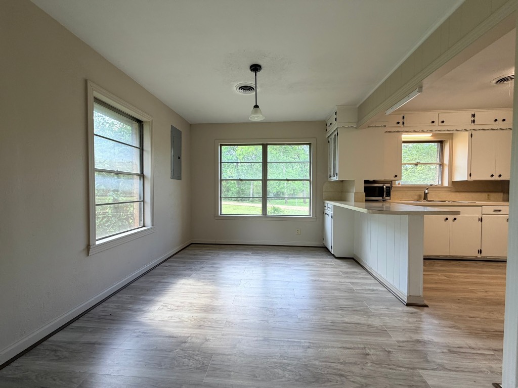 612 Keith Street Kennard, TX 75847 - Photo 10 of 15 a view of a kitchen with a sink cabinets and wooden floor
