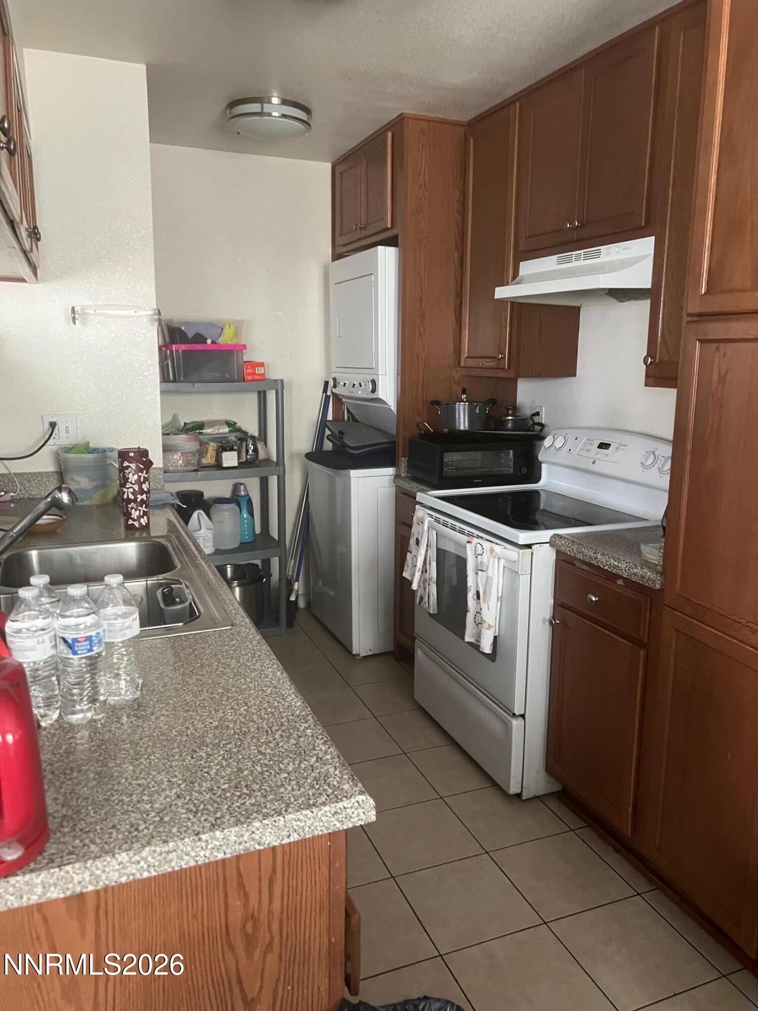 5021 Catalina Drive, Unit 2 Reno, NV 89502 - Photo 3 of 9 a kitchen with stainless steel appliances granite countertop a sink stove and refrigerator