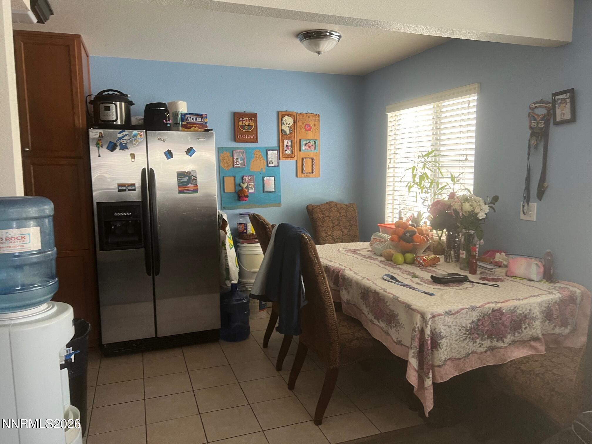 5021 Catalina Drive, Unit 2 Reno, NV 89502 - Photo 4 of 9 a dining room with stainless steel appliances a table and a refrigerator