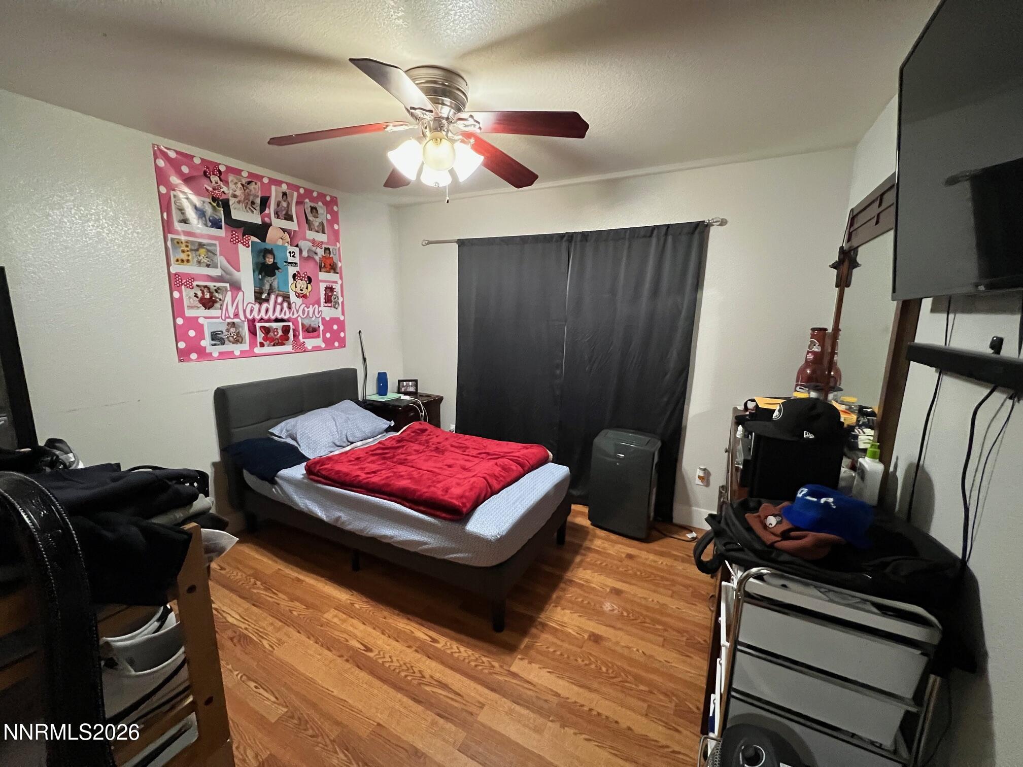 5021 Catalina Drive, Unit 2 Reno, NV 89502 - Photo 6 of 9 a bedroom with a bed and a flat screen tv