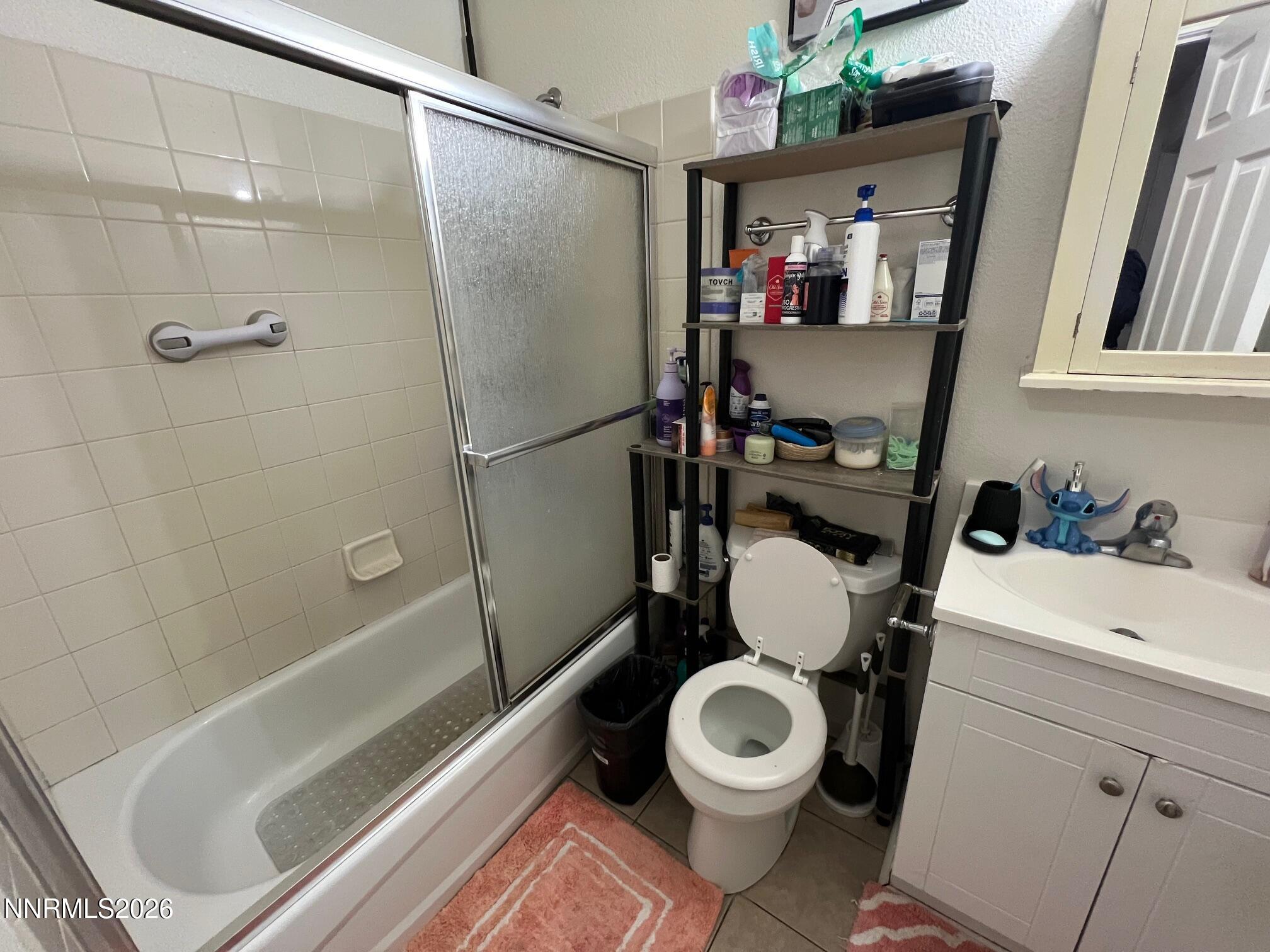 5021 Catalina Drive, Unit 2 Reno, NV 89502 - Photo 8 of 9 a bathroom with a sink toilet and shower