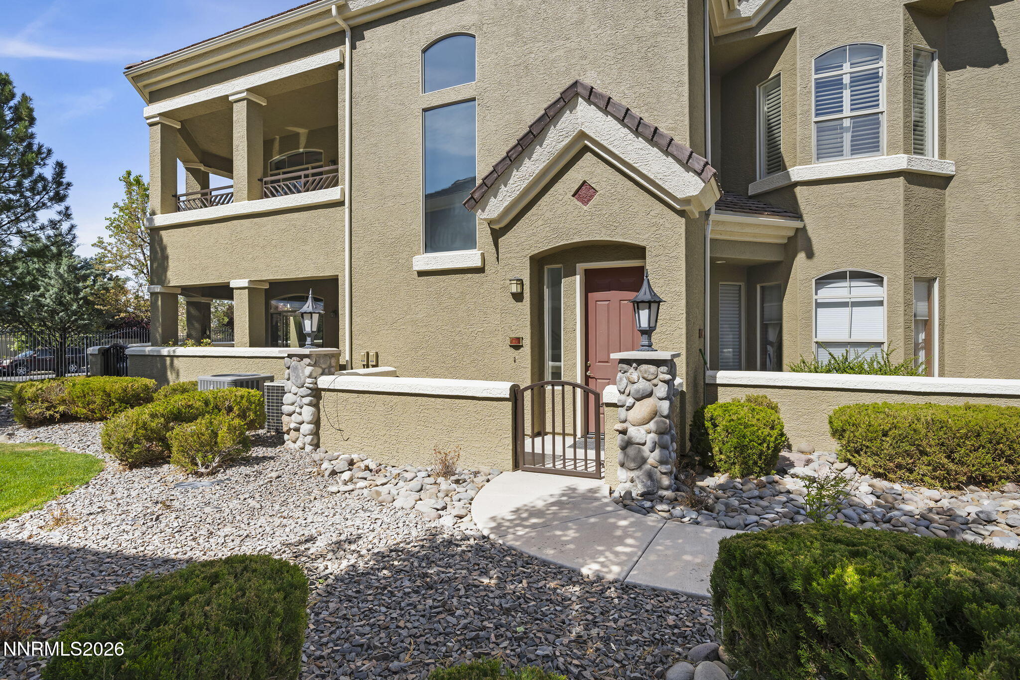 9900 Wilbur May Parkway, Unit 304 Reno, NV 89521 - Photo 2 of 47 a front view of a house with garden