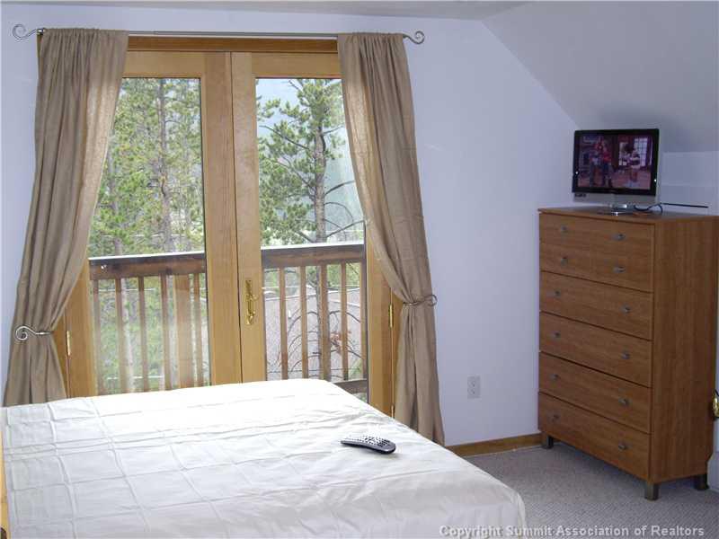 79 Bearing Tree Road Breckenridge, CO 80424 - Photo 11 of 25 a bedroom with a bed and a dresser