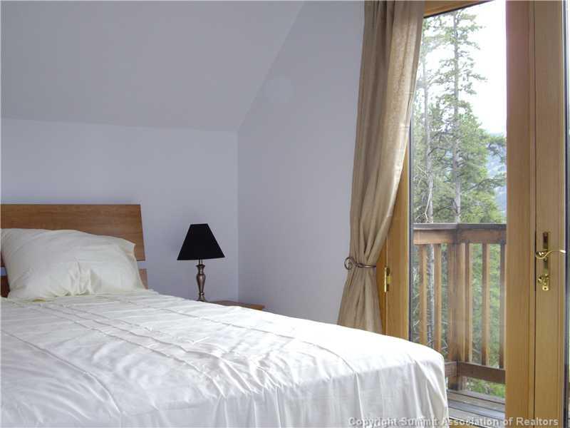 79 Bearing Tree Road Breckenridge, CO 80424 - Photo 20 of 25 a bedroom with a bed and a large window