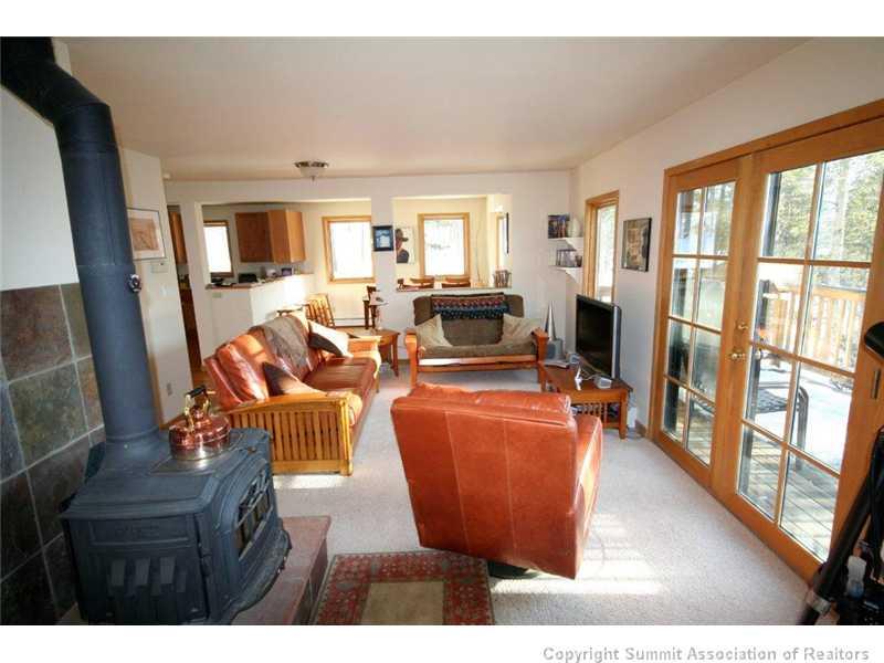 79 Bearing Tree Road Breckenridge, CO 80424 - Photo 3 of 25 a living room with furniture a large window and wooden floor
