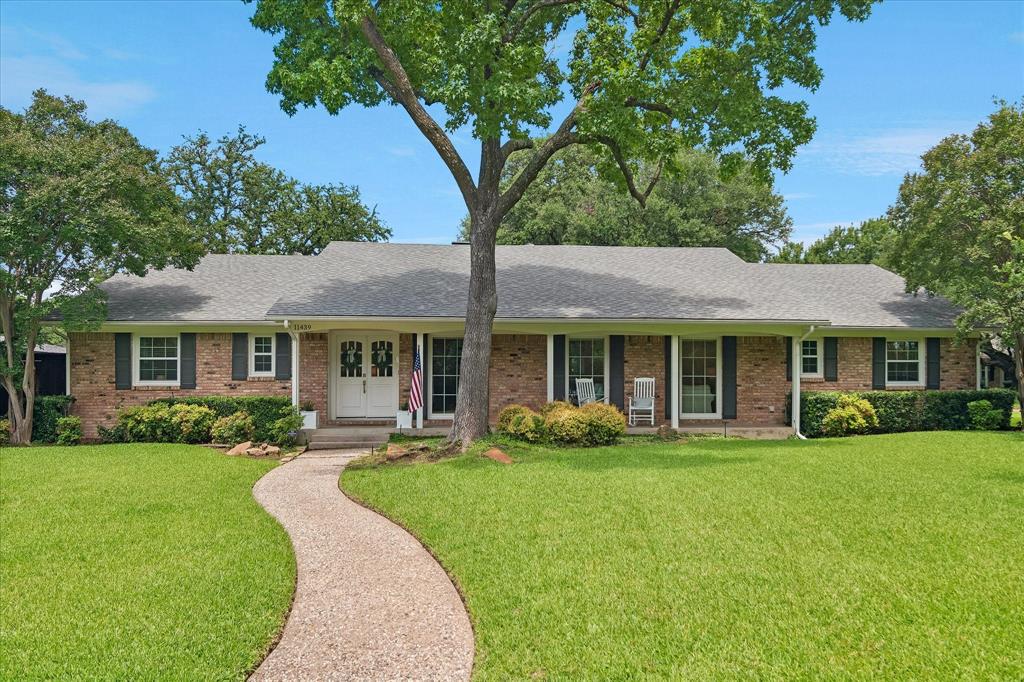 11439 Rosser Road Dallas, TX 75229 - Photo 1 of 35 a front view of a house with a yard table and chairs