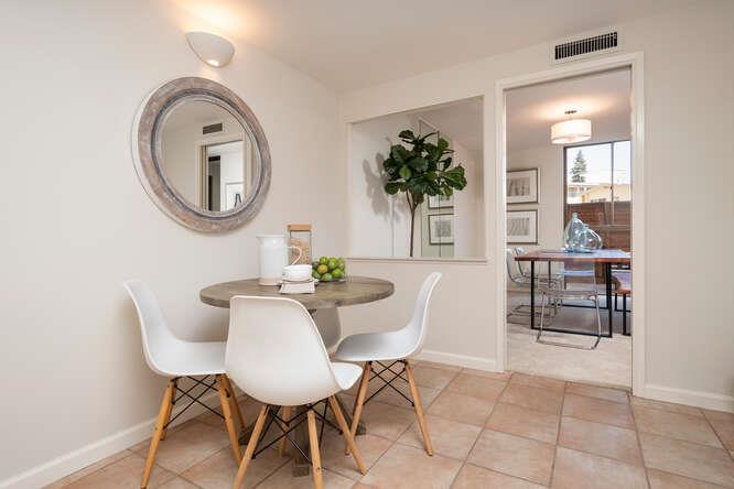 110 Park Road, Unit 108 Burlingame, CA 94010 - Photo 15 of 27 a dining room with furniture and a mirror