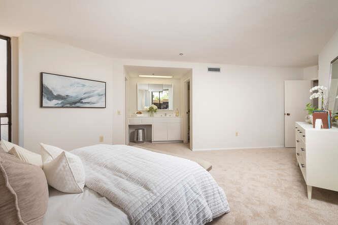 110 Park Road, Unit 108 Burlingame, CA 94010 - Photo 17 of 27 a bedroom with a bed and a couch