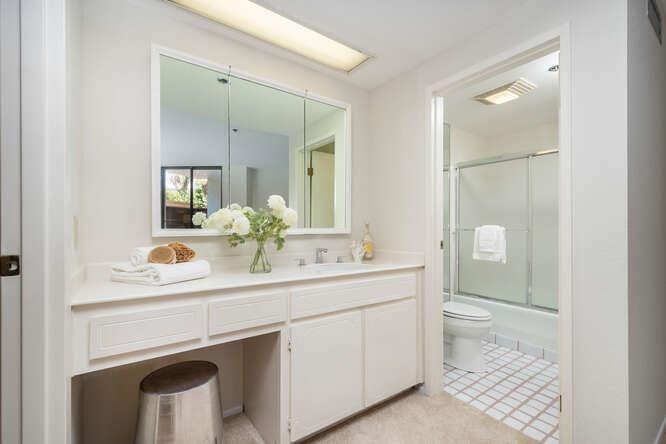 110 Park Road, Unit 108 Burlingame, CA 94010 - Photo 18 of 27 a bathroom with a sink a toilet and mirror