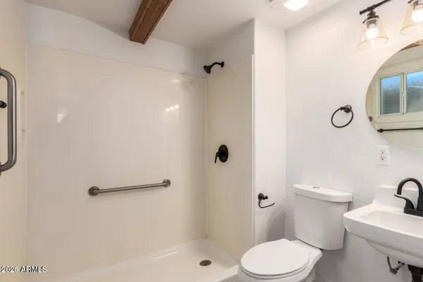 a white toilet sitting next to a bathroom sink