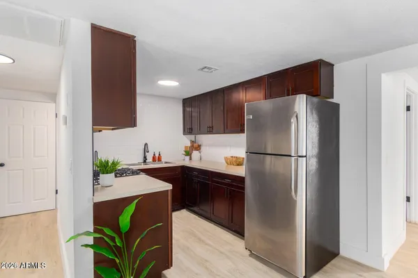 a kitchen with stainless steel appliances granite countertop a refrigerator and a sink