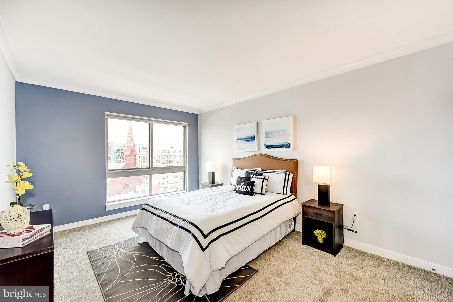 777 7th Street Northwest, Unit 924 Washington, DC 20001 - Photo 14 of 25 a bedroom with a bed and a window