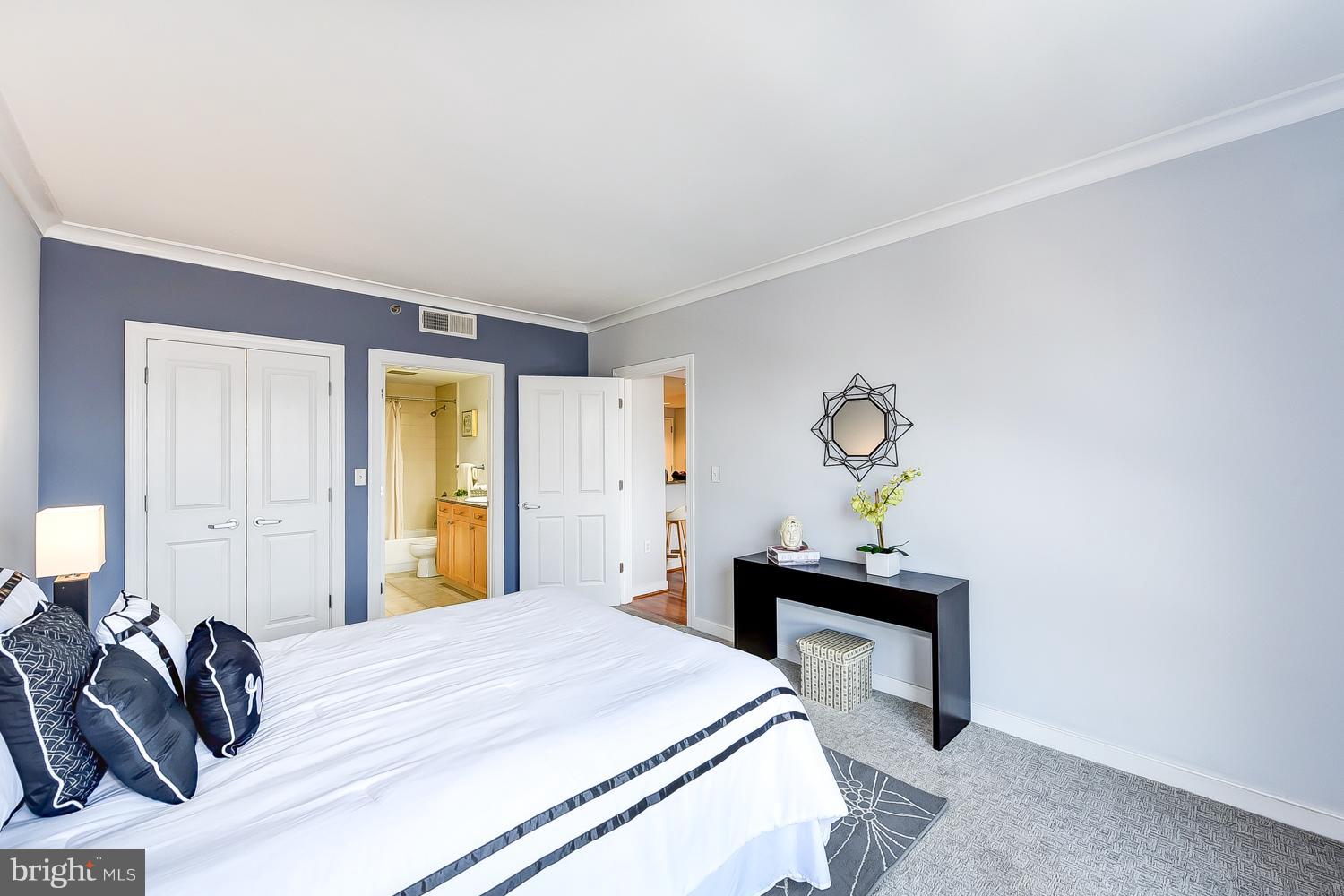 777 7th Street Northwest, Unit 924 Washington, DC 20001 - Photo 17 of 25 a bedroom with a bed and a table