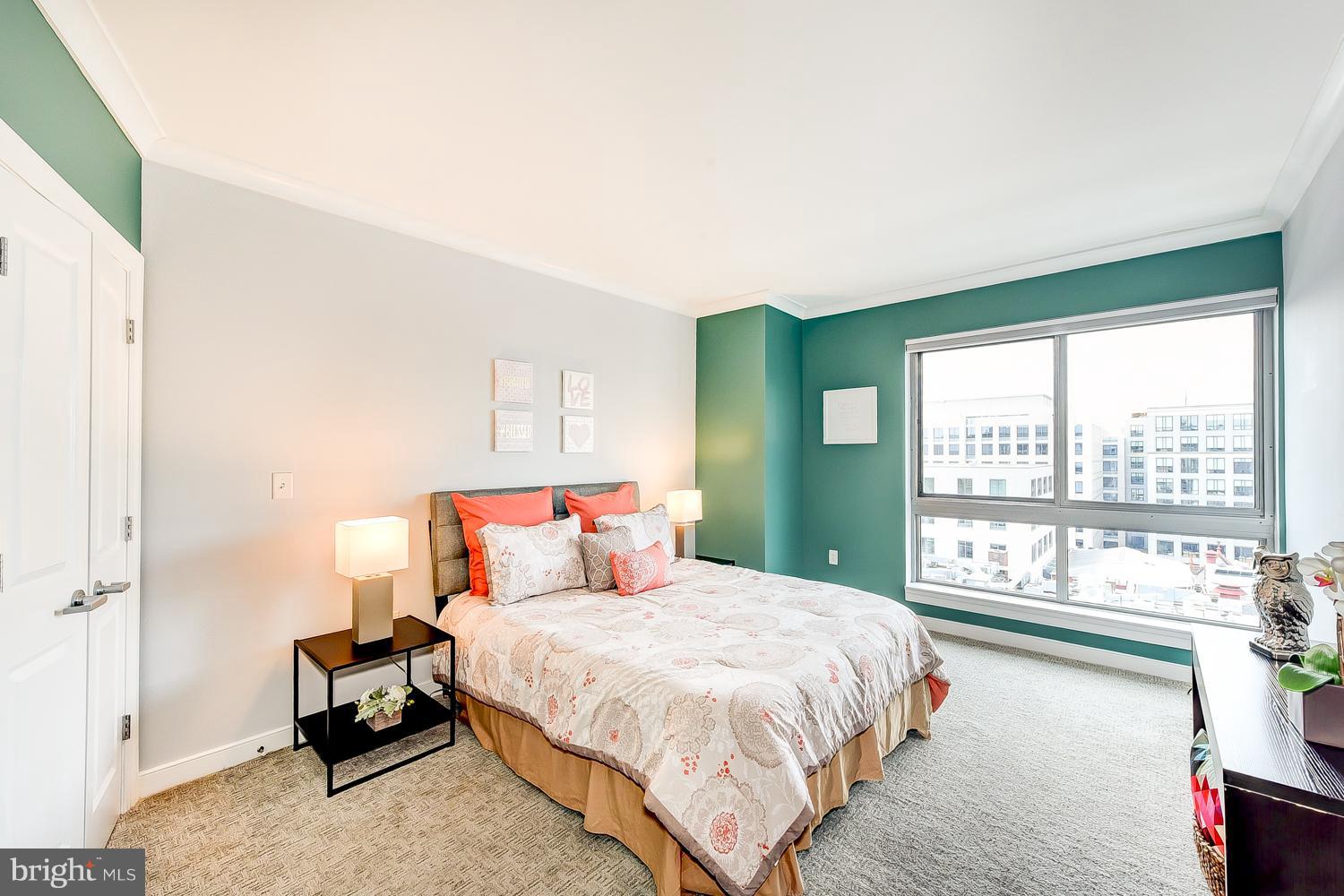777 7th Street Northwest, Unit 924 Washington, DC 20001 - Photo 20 of 25 a bedroom with a large bed and a large window