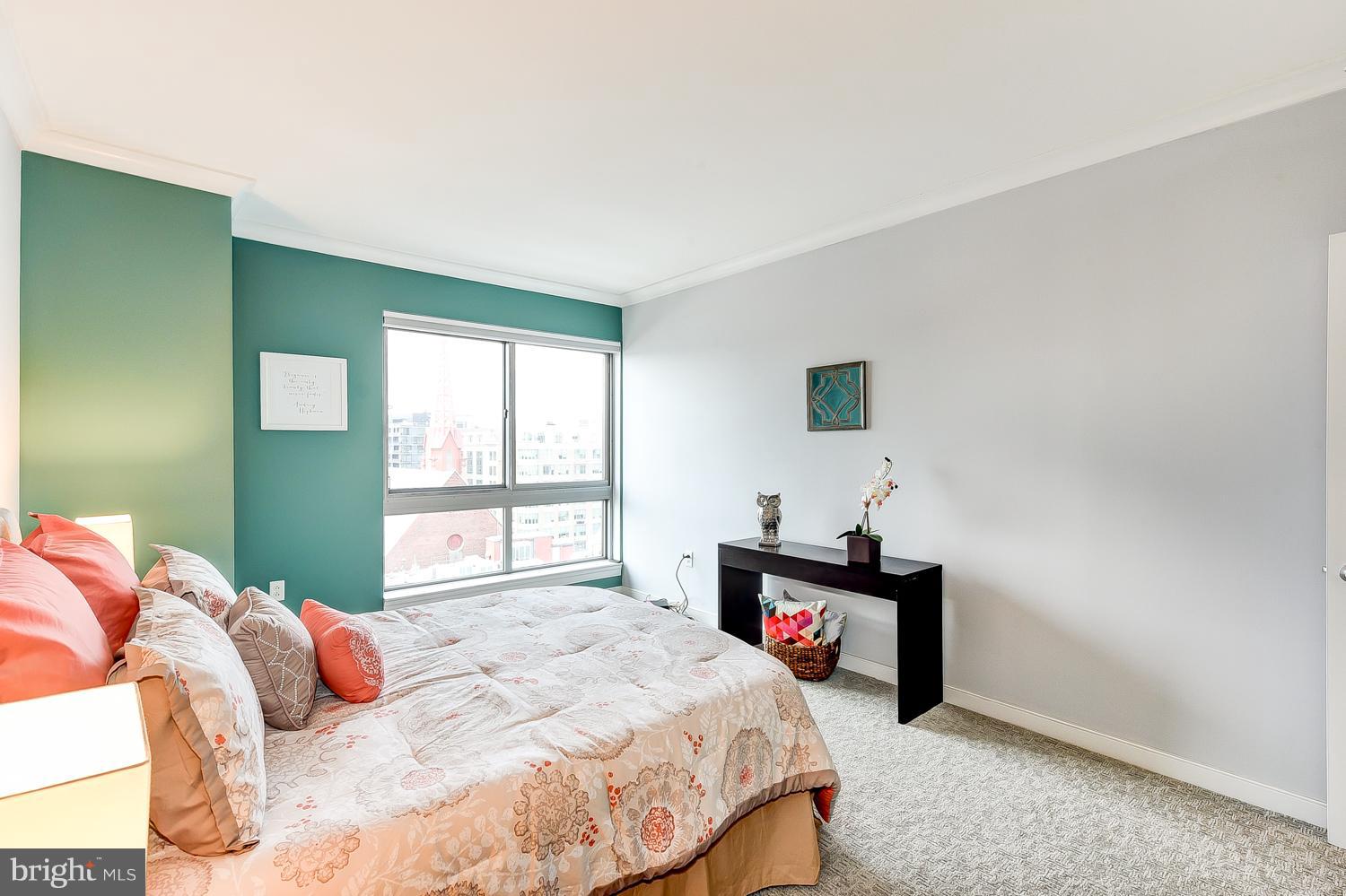 777 7th Street Northwest, Unit 924 Washington, DC 20001 - Photo 22 of 25 a bedroom with a bed and a window