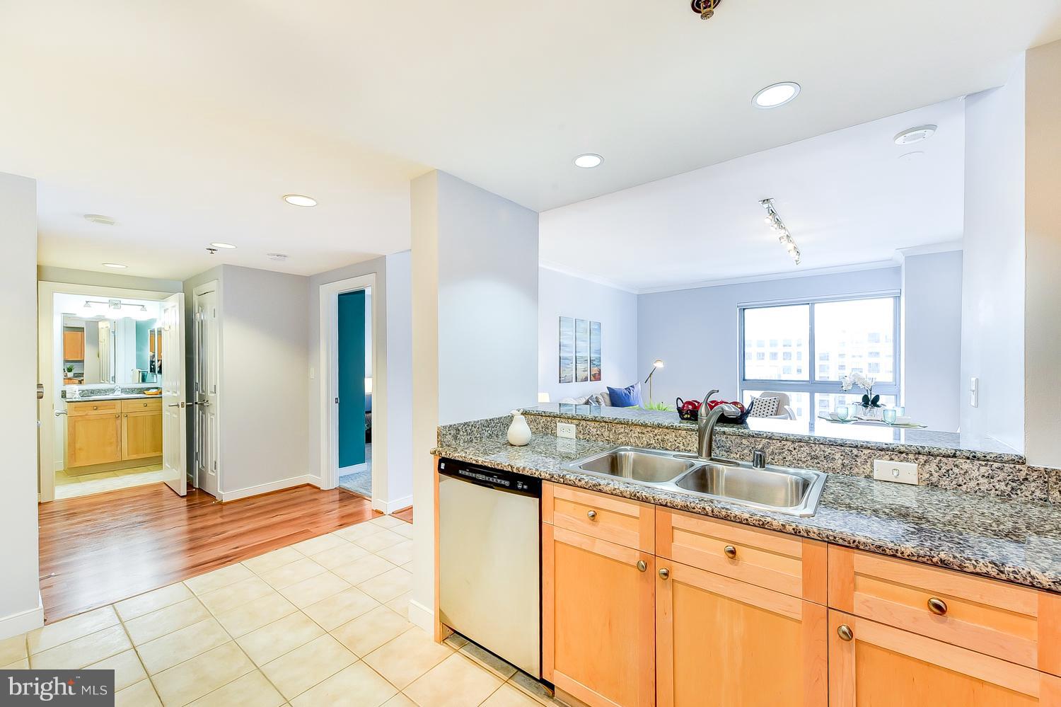 777 7th Street Northwest, Unit 924 Washington, DC 20001 - Photo 6 of 25 a kitchen with granite countertop a sink and a stove top oven
