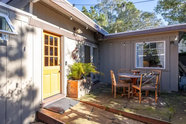 a view of a patio with table and chairs and potted plants