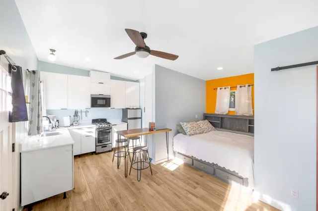a living room with furniture and a wooden floor