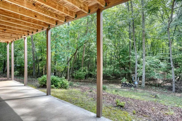 a living room with furniture and large windows
