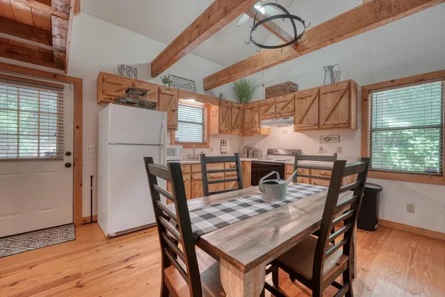 a kitchen with stainless steel appliances granite countertop a sink a stove and cabinets