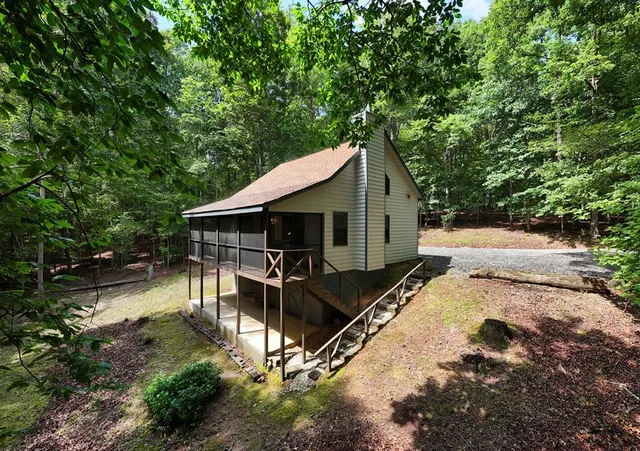 a backyard of a house with table and chairs